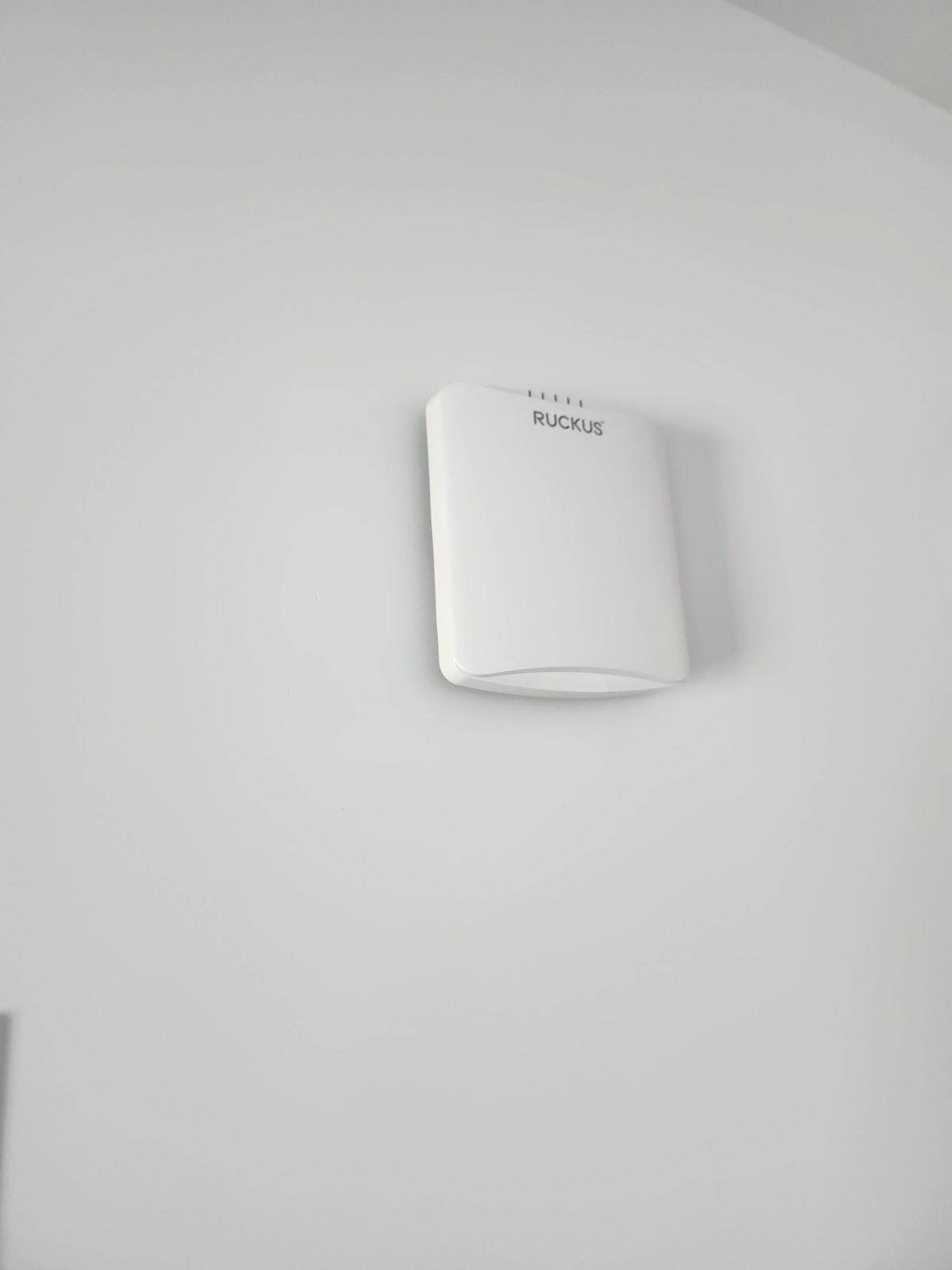 Close view of a wall-mounted Ruckus access point at the Mauldin apartment property