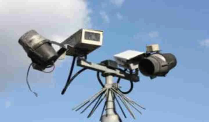 Several outdoor security cameras mounted on a pole