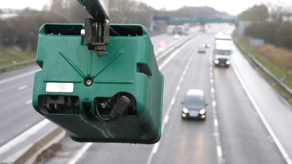 Roadside license plate camera overlooking traffic on a highway