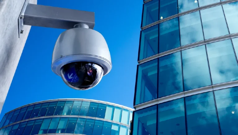 Dome security camera outside a glass office building